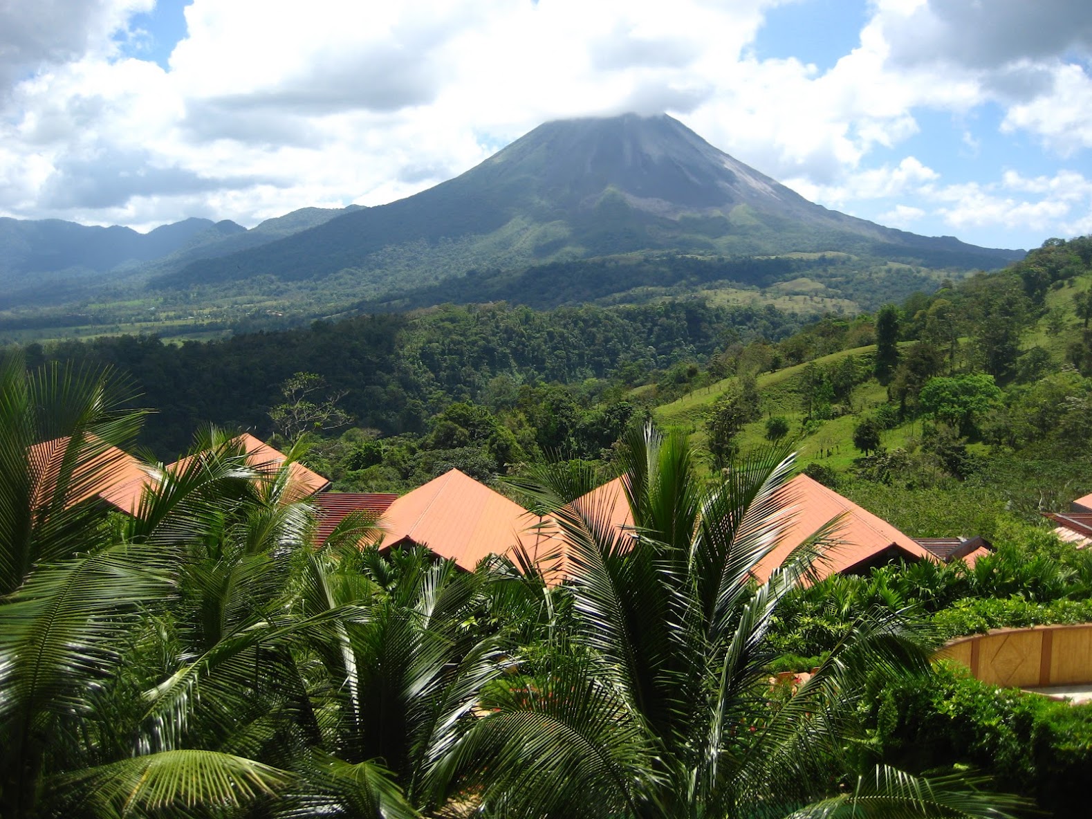 Look a that beautiful active volcano, it is massive, lush, beautiful and still releasing lava.