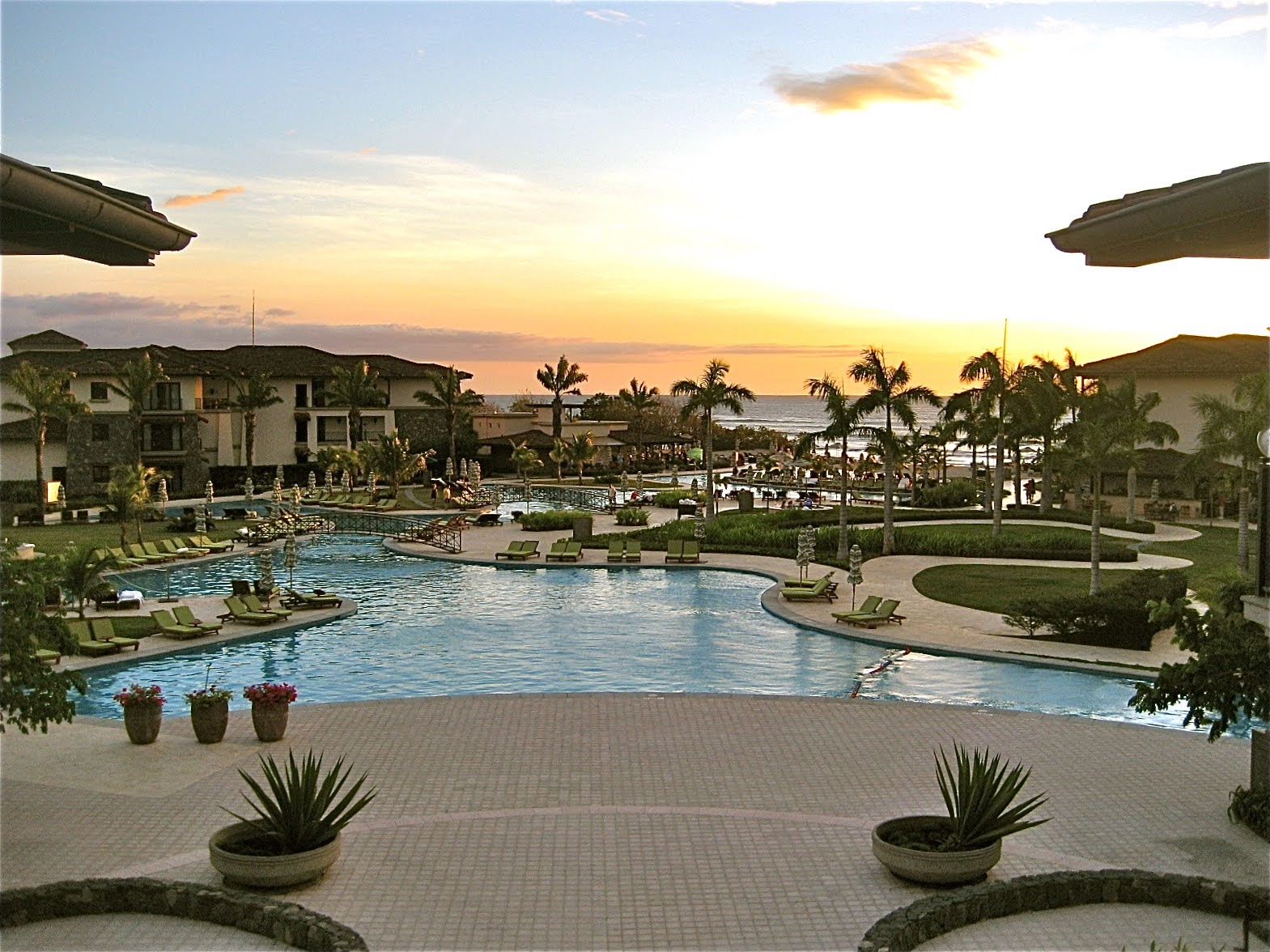 Sunset views from the entrance balcony of the pool and the ocean.