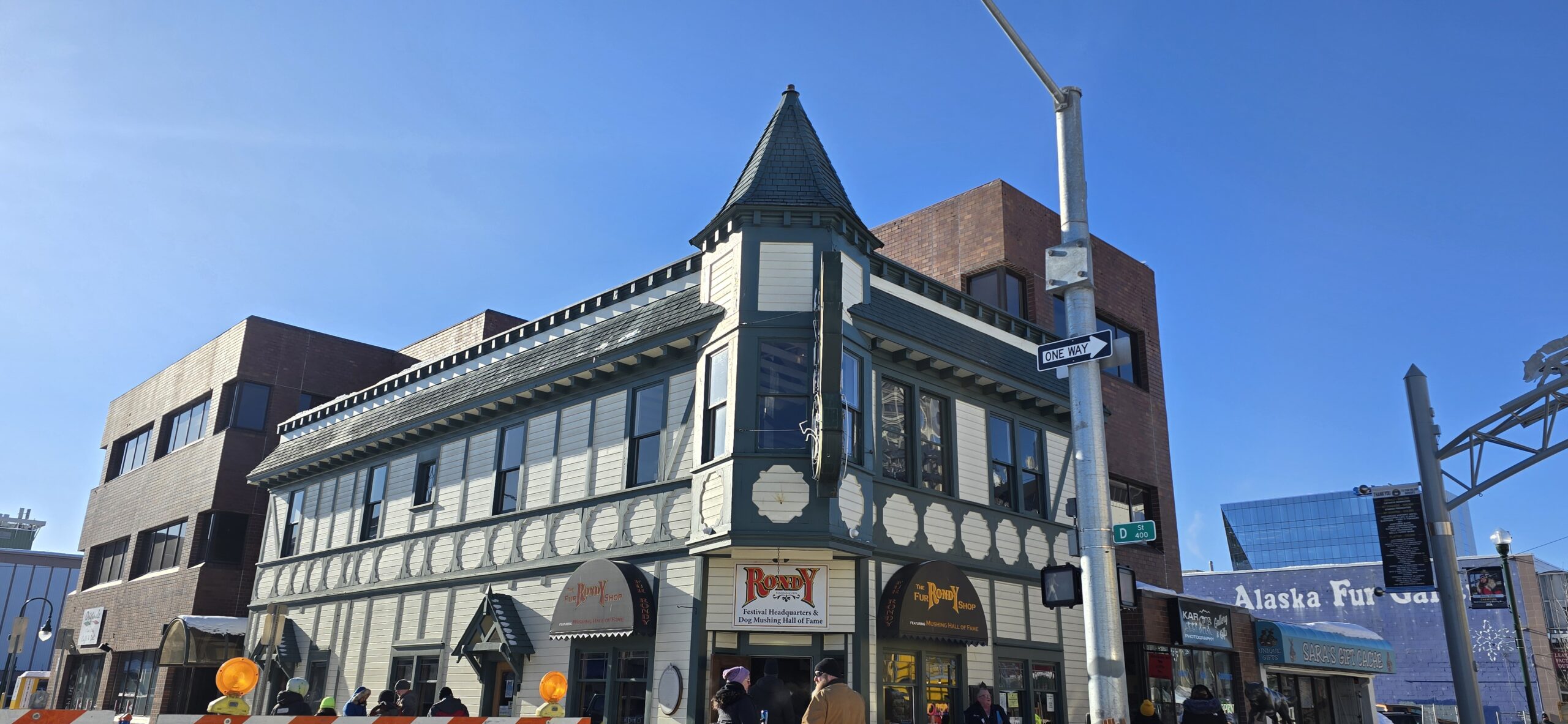 That is the Rondy headquarters and the oldest commercial building in the Municipality of Anchorage, known as The Wendler building, built in 1915 by Tony and Florence Wendler, first it was a store then they converted to a boarding house, then Mrs. Wendler and her daughters opened Club 25 as an exclusive private club for women.  The Wendler building was also moved from its original location at 4th and I Street to its current location and in 1988 was listed on the U.S. National Register of Historic Places in Anchorage, Alaska.